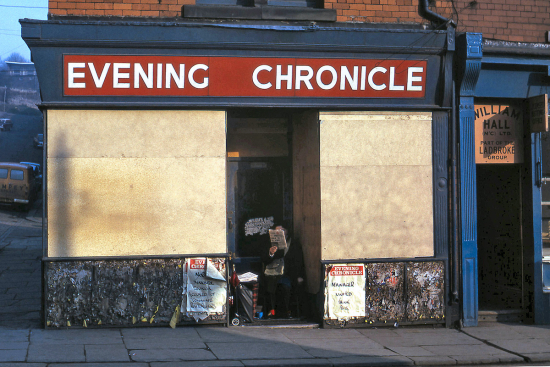 Ermel-The-Evening-Chronicle-seller-in-an-apt-sheltered-spot-in-Byker-in-1975.-